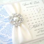 save the date cards with ivory ribbon and powder blue damask detail